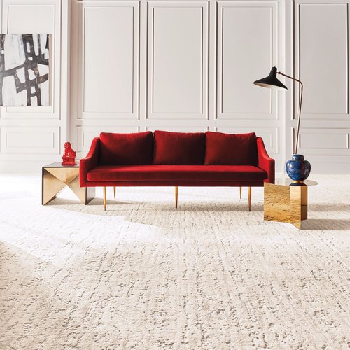 A red couch on a white carpet from Pala Tile and Carpet in Elsmere